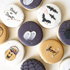 many decorated cookies are arranged on a white surface with words written in the icing