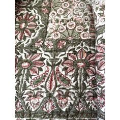 an embroidered fabric with red and green flowers on white, black and grey colors is shown