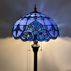 a stained glass lamp sitting on top of a wooden table