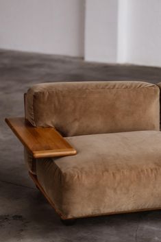 a brown chair with a wooden table on it