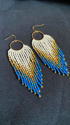 Beaded earrings with fringe, handmade with love 💙💛 Gold Heishi Beads Earrings, Gold Dangling Heishi Beads Earrings, Gold Heishi Bead Earrings With Colorful Beads, Gold Heishi Beaded Earrings With Colorful Beads, Gold Beaded Fringe Earrings For Beach, Gold Beaded Earrings With Fringe, Gold Bohemian Beaded Earrings With Fringe, Gold Beach Jewelry With Beaded Fringe, Gold Tassel Earrings With Colorful Beads