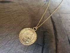 Long coin necklace, 14k gold necklace, gold coin necklace, coin pendant necklace, medallion necklace, coin necklace, gold pendant necklace A replica of an old Greek coin made of gold which I wrapped around with twisted wires in order to make it into a beautiful gold coin pendant. The gold coin is not a perfect circle in shape and is a little rustic. The necklace is made of 14k gold filled. This long gold coin necklace is great for everyday wear, unique and beautiful. The coin pendant necklace is Gold Medallion Coin Necklace In Brass, Gold Brass Medallion Coin Necklace, Brass Coin Medallion Necklace, Brass Medallion Coin Necklace, Brass Necklaces With Coin Pendant In Round Disc Shape, Brass Necklaces With Coin Pendant, Brass Coin Pendant Necklace In Medallion Shape, Brass Medallion Necklace With Coin Pendant, Tarnish-resistant Yellow Gold Coin Necklace