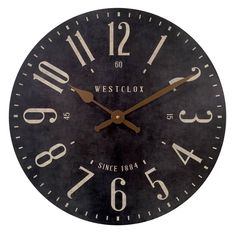 a black clock with white numbers on the face and hands is shown against a white background