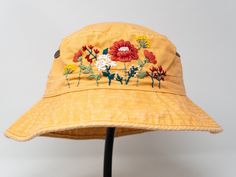 This hand embroidered cotton bucket hat is a stylish accessory that combines function with unique, handmade design. Made from high-quality cotton, it provides comfort and protection from the sun, making it perfect for outdoor activities. The intricate floral embroidery is meticulously crafted by hand, giving each hat a one-of-a-kind touch. Whether you're at the beach, camping, or just running errands, this cotton hat is both practical and fashionable. Item: flower embroidered bucket hat Material Yellow Cotton Bucket Hat With Short Brim, Adjustable Embroidered Cotton Hat, Yellow Cotton Bucket Hat With Curved Brim, Yellow Adjustable Cotton Bucket Hat, Summer Cotton Hat With Embroidery, Summer Cotton Embroidered Hats, Embroidered Cotton Summer Hat, Handmade Yellow Cotton Hats, Red Embroidered Cotton Hat