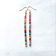 Colorful Boho Handmade Glass Seed Beaded Dangle Stick Earrings Finished With Gold Tone Hook Ear Wires Gypsy Hippie Retro Mod Nickel Free Gold Tone Hook Ear Wires With Clear Backs To Help Keep In Place Dainty Tiny Glass Seed Beads In Multi Colors, Randomly Chosen By Me To Create You A Beautiful Unique Pair Of Earrings Using The Same Bead Colors Yet Randomly Selected Approximately 3.25 Inch Length Handmade Beautiful Earrings To Wear Daily Or Give As A Gift For Christmas, Anniversary, Birthday, Val Glass Seed Bead Earrings, Minimalist Beaded Earrings, Adjustable Beaded Earrings With Dangling Beads For Everyday, Handmade Multicolor Heishi Beads Earrings, Trendy Adjustable Beaded Earrings With Dangling Beads, Trendy Dangle Beaded Earrings For Festivals, Trendy Beaded Dangle Earrings For Festival, Trendy Festival Dangle Beaded Earrings, Colorful Adjustable Heishi Beaded Earrings