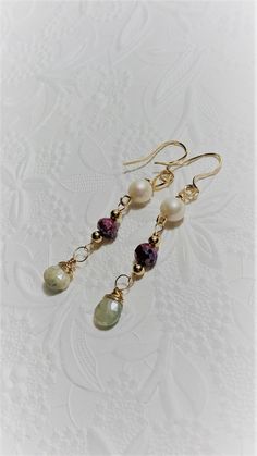 "Earrings of Pink Silverite, Gray Silverite , White Freshwater Pearls set with 14K Gold Filled wire make up these lovely handmade long drop earrings. They are beautifully colored in shades of pink,gray, ,white and gold. The white freshwater pearls are approx. 9mm. The pink silverite faceted rondelles are approx. 8mm wide. The Gray silverite Faceted Brioltettes are approximatly 9mm wide and 10mm long. Wear them out on the town or in the evening. A rare pair of Earring. they measure 2 3/4\" inches Pink Drop Earrings, Green Amethyst Earrings, Rose Quartz Earrings, Pearl Pink, Blue Topaz Earrings, Long Drop Earrings, Earrings Pearl, Topaz Earrings, Gold Filled Earrings