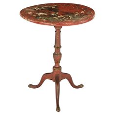 an old wooden table with marble top on it's legs and two small feet