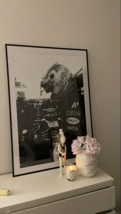 a framed photograph sitting on top of a white dresser