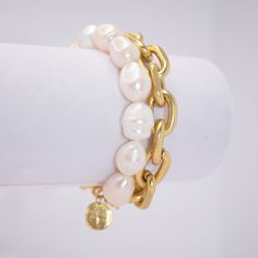 Elegant strand of large, lustrous, cultured pearl, matched with a thick link gold chain. PRODUCT DETAILSMaterials: Pewter alloy base plated with 24-kt gold / sterling silver. fresh water pearlsMeasurements: ﻿7.5" longClosure: Toggle clasp White Pearl Bracelet With Chain Detail, White Pearl Bracelet With Chain, Pearl Jewelry With Chunky Chain For Gift, Gold Pearl Bracelet With Oyster Detail, Gold Pearl Chain Link Jewelry, Gold Chain Link Jewelry With Pearl Chain, Gold Pearl Bracelet With Chain As Gift, Gold Pearl Bracelet With Oyster Design, Gold Metal Pearl Bracelet With Pearl Charm