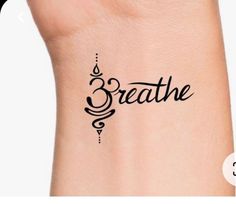 the word breathe written in cursive writing on a woman's arm with an arrow