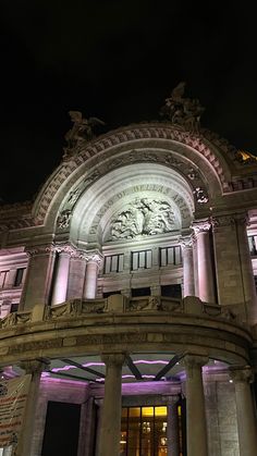 an ornate building lit up with purple lights