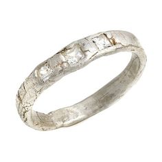 a silver ring with three stones on the inside and outside, set against a white background