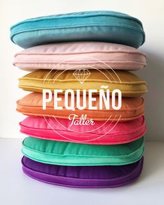 a stack of pillows with the words pequeno written in white on top of them