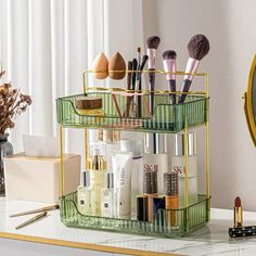 the makeup organizer is sitting on top of a counter next to a mirror and brush