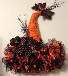 an orange and black decoration hanging on the wall