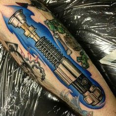 a man with a tattoo on his arm has a rocket ship in the sky and clouds