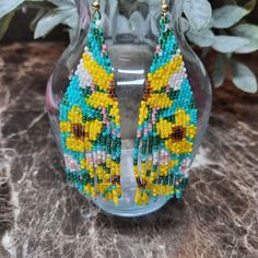 Shop ascsbeauty1's closet or find the perfect look from millions of stylists. Fast shipping and buyer protection. These beautiful YELLOW FLOWER fringe earrings were beaded by me using Japanese Delica Beads in the colors Canary Yellow, Topez, Rootbeer, Blue Turquoise, Dark Green Rainbow and Coral Luster. They measure approximately 4" in length and 1.25 in width. I hope you enjoy wearing them as much as I had making them. Yellow Beaded Earrings With Ear Wire For Summer, Summer Yellow Beaded Earrings With Ear Wire, Yellow Dangling Beads Earrings For Summer, Summer Yellow Dangling Beads Earrings, Yellow Summer Earrings With Dangling Beads, Summer Yellow Earrings With Dangling Beads, Bohemian Yellow Beaded Dangle Earrings, Yellow Bohemian Earrings For Summer, Bohemian Yellow Earrings For Beach