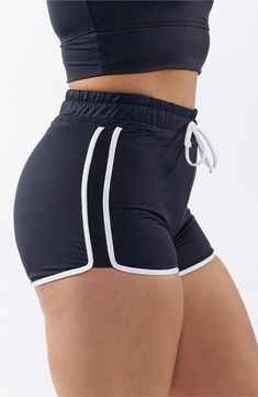 You will move with ease from land to sea in these stretch-enhanced swim shorts topped with a high waist. 3 1/2" inseam   Lined   80% recycled polyester; 20% spandex   Hand wash, line dry   Imported High Waist Biker Shorts With Built-in Shorts For Beach, Black Swimwear With Built-in Shorts, Sporty Black Swimwear With Built-in Shorts, Sportswear Swimwear For Yoga In Summer, Summer Sportswear Swimwear For Yoga, Black Beachwear Shorts With Elastic Waistband, Sporty Swim Skirt For Workout, Solid Color Sportswear Swimwear For Summer, Summer Sportswear Swimwear In Solid Color