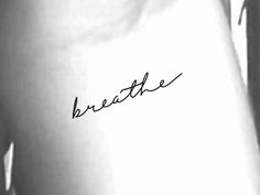 a woman's stomach with the word breathe written in cursive writing on it