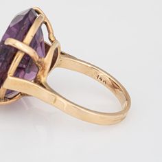 Stylish vintage amethyst & seed pearl ring (circa 1950s to 1960s) crafted in 14 karat yellow gold.   Round faceted amethyst measures 21mm diameter (estimated at 23 carats). The 9 seed pearls each measure 1.5mm. The amethyst is in very good condition and free of cracks or crisps (few light surface abrasions from normal wear).   The rich royal purple amethyst is set with a star pattern of seed pearls, uniquely flush set into the amethyst. The statement ring adds a nice pop of colour on the hand. T Vintage Oval Amethyst Ring In 14k Gold, Formal Vintage Amethyst Ring, Vintage Yellow Gold Amethyst Ring, Vintage Gold Amethyst Rings, Vintage Faceted Yellow Gold Rings, 14k Gold Vintage Amethyst Ring For Formal Occasions, Vintage Faceted Rings For Anniversary, Vintage 14k Gold Amethyst Ring Hallmarked, Vintage Amethyst Ring With Prong Setting For Anniversary