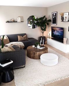 a living room filled with furniture and a flat screen tv mounted on the wall above it