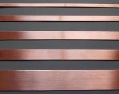 four different types of metal strips on a gray surface