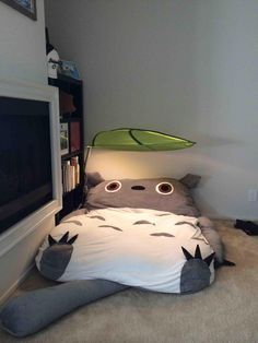 a bed that is made to look like a cat with eyes on its head and tail