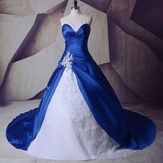 a blue and white wedding gown on display