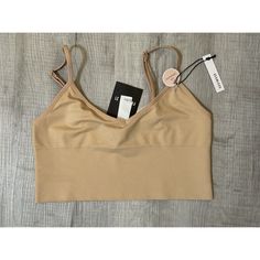 New With Tags Forever 21 Size Small/Medium Material: 93% Nylon/Polyamide 7% Spandex/Elastane Comes From Smoke Free & Pet Free Home Trendy Beige Crop Top With Built-in Bra, Trendy Fitted Workout Bra, Trendy Workout Fitted Bra, Fitted Beige Sports Bra With Removable Pads, Fitted Beige Sports Bra With Built-in Bra, Beige Seamless Sports Bra, Seamless Beige Bra For Spring, Beige Seamless Construction Sports Bra, Fitted Seamless Beige Sports Bra