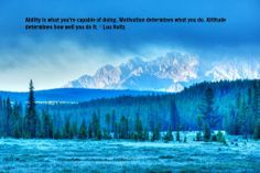 the mountains are covered in snow and trees, with a quote from person on it