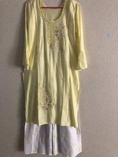 A nice lemon embroidered cotton kurti with white plaajo! Size 38-44 Length: 42' Arm length: 16 Plaajo length: 39' Spring Festive Salwar Kameez With Gota Work, Spring Chanderi Palazzo Set With Straight Kurta, Designer Cotton Off White Palazzo Set, Spring Resham Embroidered Straight Kurta Palazzo Set, Spring Salwar Kameez With Gota Work And Long Sleeves, Spring Long Sleeve Salwar Kameez With Gota Work, Spring Yellow Palazzo Set With Resham Embroidery, Spring Festive Sharara With Cutdana, Bollywood Style Kurta With Gota Work For Spring