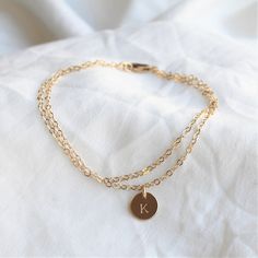 Our Double Chain Bracelet comes in silver, rose or gold chain options. Two sparkling chains for a minimal and chic look for everyday. Adorned with a tiny initial disc for that extra special touch.  Makes the perfect gift too!_______________________________________D E T A I L S--Two layers of dainty link chain-8mm initial disc. -High quality 14kt gold filled, rose filled or sterling silver - not plated.-Premium lobster claspLENGTH- Please select from the drop down selection.- Fits most sizing:6.0 Minimalist Stainless Steel Charm Bracelet For Friendship, Minimalist Stainless Steel Friendship Charm Bracelet, Adjustable Minimalist 14k Gold Filled Charm Bracelet, Minimalist Stainless Steel Chain Bracelet For Friendship, Minimalist Metal Name Bracelet As Gift, Minimalist Stainless Steel Friendship Bracelet, Minimalist Hypoallergenic Jewelry For Friendship, Minimalist Hypoallergenic Jewelry, Dainty Chain Bracelet With Charms For Gift