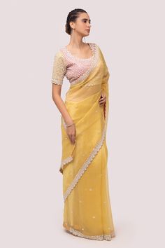 Mustard saree in organza base with sequins, stone and cutdhana embroidery. Paired with embroidered blouse.
Component: 2
Pattern: Embroidered
Type Of Work: Sequin, stone, cutdhana
Neckline: Round
Sleeve Type: Half
Fabric: Organza
Color: Yellow
Other Details: 
Back tassel tie-up
Occasion: Puja - Aza Fashions Yellow Georgette Saree, Designer Saree Blouse, Reception Saree, Georgette Saree, Organza Saree, Traditional Sarees, Orange Fashion, Thread Work, Georgette Sarees