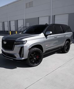 a silver suv parked in front of a building