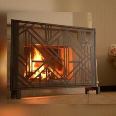 a fire is burning in a fireplace with metal bars on the front and back sides