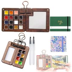 an assortment of art supplies including a notebook, pen, and photo album with the contents laid out