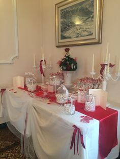 the table is set with candy and candles for an elegant wedding breakfast or bridal party