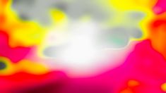 a blurry image of an orange, yellow and pink substance with white clouds in the background