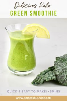 a green smoothie in a glass with a lemon slice on the side and an artichoke next to it