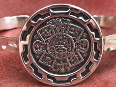 This is a Silver Aztec Calendar / Sun Stone Cuff Bracelet It is made by 925 Silver Aztec Calendar bracelet / Sun Stone Bracelet weight : 10 gr Symbolic Engraved Sterling Silver Cuff Bracelet, Symbolic Sterling Silver Adjustable Bracelet, Sterling Silver Symbolic Adjustable Bracelet, Adjustable Symbolic Sterling Silver Bracelet, Adjustable Sterling Silver Symbolic Bracelet, Silver Etched Round Bracelets, Etched Sterling Silver Bracelet As Gift, Etched Sterling Silver Bracelet Gift, Adjustable Etched Round Bracelets