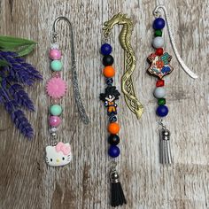 several necklaces and charms on a wooden surface