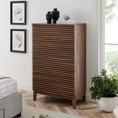 a wooden cabinet sitting in the corner of a room