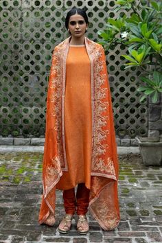 Rust orange silk embroidered kurta in aari and moti work. Paired with churidar and applique work dupatta.
Components:3
Pattern:Embroidery
Type of Work:Moti and aari
Neckline:Round
Sleeve Type:Long sleeves
Fabric:Silk,Organza
Color:Orange
Other Details:
Applique work
Paisley and floral motifs
Occasion:Wedding - Aza Fashions Transitional Orange Zari Work Kurta, Orange Dabka Embellished Straight Kurta, Orange Dupatta With Intricate Embroidery, Orange Fitted Dupatta With Intricate Embroidery, Luxury Semi-stitched Orange Kurta, Churidar, Silk Organza, Silk Embroidery, Embroidered Silk