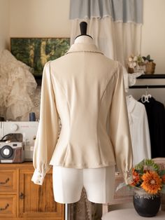 Add a touch of Victorian elegance to your wardrobe with this beige long-sleeve shirt featuring a detachable jabot on the neckline. Perfect for adding a sophisticated and gothic twist to your outfit, this versatile piece can be dressed up or down for any occasion.  This price includes a shirt and a detachable jabot.   	 		 			Size 			S 			M 			L 			XL 			2XL 		 		 			Shoulders 			38 			39.5 			41 			42.5 			44 		 		 			Bust 			86 			92 			98 			104 			110 		 		 			Waist 			68 			74 			80 			86 Fitted Beige Long Sleeve Blouse, Beige Fitted Long Sleeve Blouse, Elegant Beige Collared Top, Fitted Blouse With Detachable Collar For Workwear, Fitted Long Sleeve Top With Detachable Collar, Elegant Long Sleeve Blouse With Detachable Collar, Elegant Fitted Blouse With Peter Pan Collar, Classic Fitted Top With Detachable Collar, Elegant Fitted Blouse With Lapel Collar