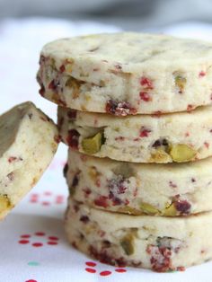 cranberry and pistachio shortbread cookies stacked on top of each other