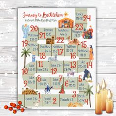 a christmas calendar with candles and nativity items on the wooden table next to it