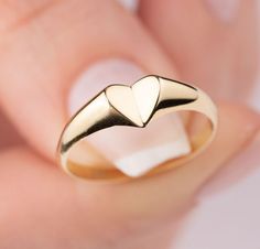 Our signet heart ring is 14k solid gold. Our gold heart ring has a unique style with looks like a folded heart. It fits your all outfit and becomes your everyday ring. When you think of our 14k gold heart ring as a gift, it is a product that will make your loved ones happy on their birthday, valentine's day, mother's day, anniversaries, graduations, or other special days. Also, it can be a perfect gift for yourself. :) 🎁 If you want, you can add a gift note for your loved ones. It arrives in a Minimalist Heart Promise Ring With Polished Finish, 14k Gold Polished Finish Promise Heart Ring, Heart Shaped Yellow Gold Signet Ring For Promise, Minimalist Heart Ring With Charm For Promise, Heart-shaped Yellow Gold Signet Ring For Promise, Minimalist Polished Heart Ring For Anniversary, Heart Shaped Yellow Gold Stackable Promise Rings, Minimalist Heart Shaped Signet Ring For Promise, 14k Gold Stackable Rings With Heart Charm For Gift