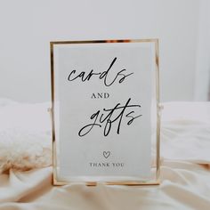 a sign that says cards and gifts in black ink on a white sheet with a gold frame