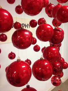 red christmas ornaments hanging from the ceiling