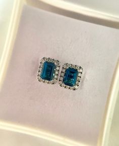 This stunning pair of earrings is studded with London blue topaz in the middle and moissanite, surrounded by 14k solid white gold. Apart from London blue topaz's deep blue colour, it is highly durable and ideal for daily wear. It is associated with tranquility and peace for the wearer of the stone and is a December birthstone. On the other hand, moissanite is one of the most durable substances on earth and is highly scratch resistant - making it perfect for daily wear. It is known to boost energ Hidden Potential, Gold Topaz, Blue Topaz Earrings, Topaz Earrings, December Birthstone, Earrings Blue, London Blue Topaz, Blue Colour, London Blue